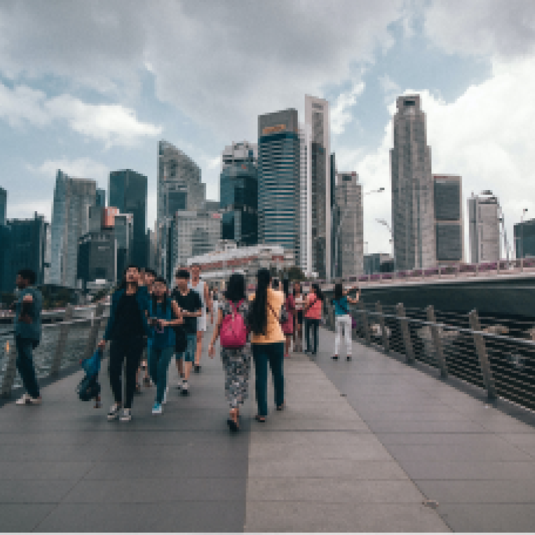Cityscape with people walking over a bridge