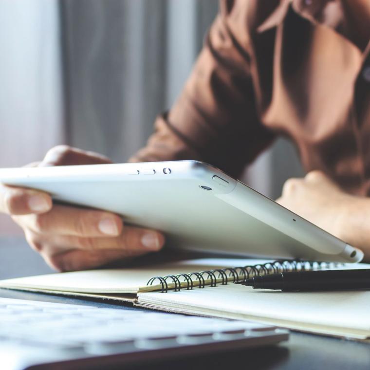 businessman working tablet in office with film colors tone, soft-focus and over light in the background