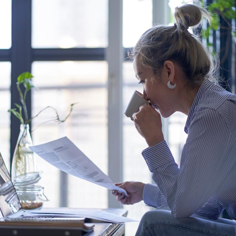 asian woman working from home looking at a model release