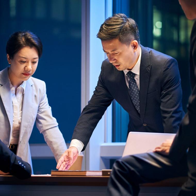 asian project team working late together meeting in office 