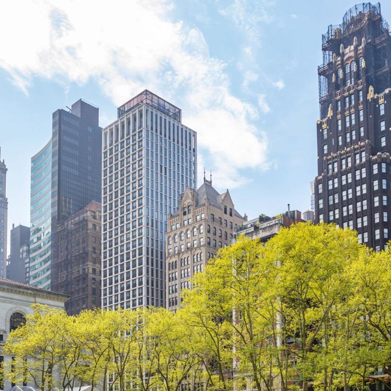 Bryant park, New York, Manhattan. High buildings view from below against blue sky background, sunny day in spring