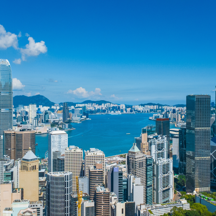 Latest October 2025 aerial view of Hong Kong business skyscrapers, Victoria Harbour, Kowloon and Hong Kong Island in beautiful clean sky and fluffy cloud