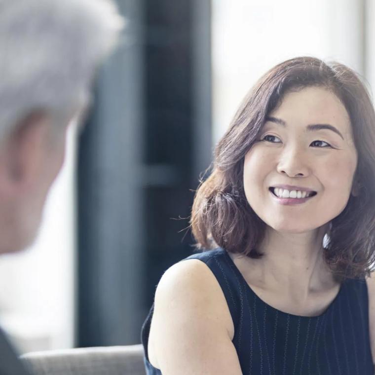 asian woman smiling in meeting