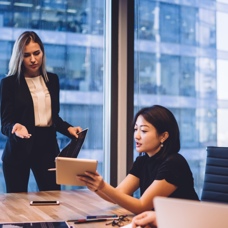 Serious businesswoman discussing project with diverse colleagues 