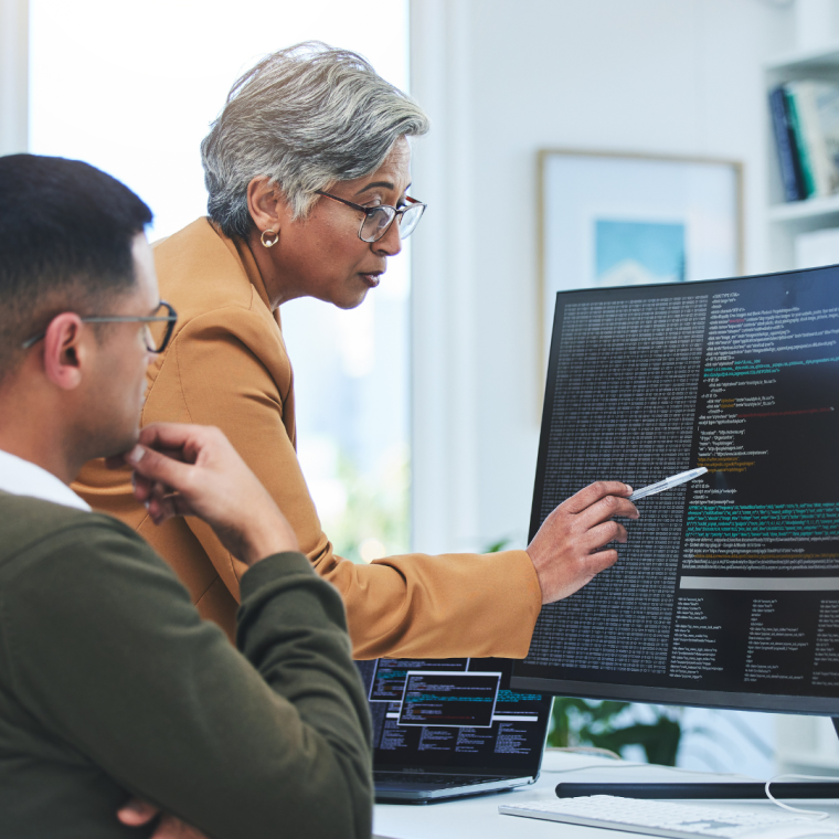 Coaching, mentor and programmer with business people and computer for coding, developer or information technology. Meeting, code review and feedback with employees in digital agency for cybersecurity