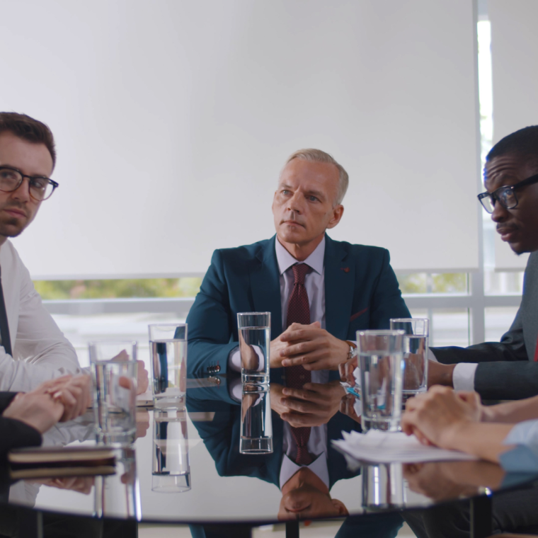 Business leader holding corporate meeting with team in boardroom 