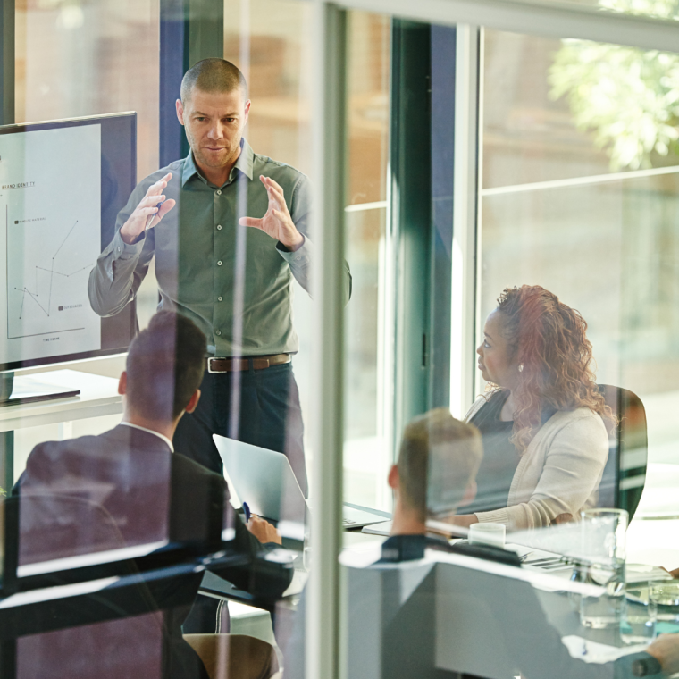 Business people, tech or advice in boardroom for training, productivity report or feedback chart on screen. Speaker, team or corporate presentation in office for company growth with brand management