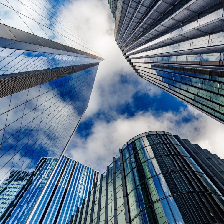 skyscraper buildings in business district, London City. Cloud on sunny day sky. Low angle view. Europe financial economy, merger and acquisition, or modern architecture concept, blue urban background
