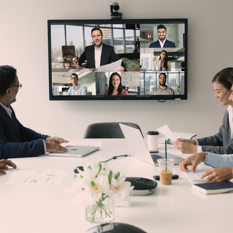 Diverse international business team discussing teamwork, work strategy, planning deal, partnership on online hybrid video conference, meeting at table and large screen, talking