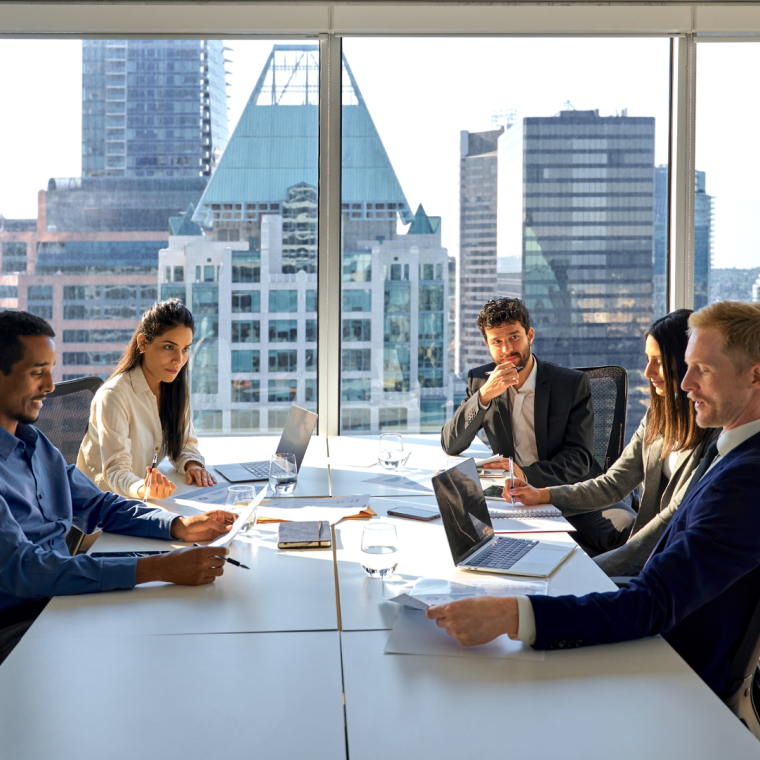 Multiethnic professional busy employees and executives board team people at group meeting discussing work results managing company project plan working together in modern board room office.