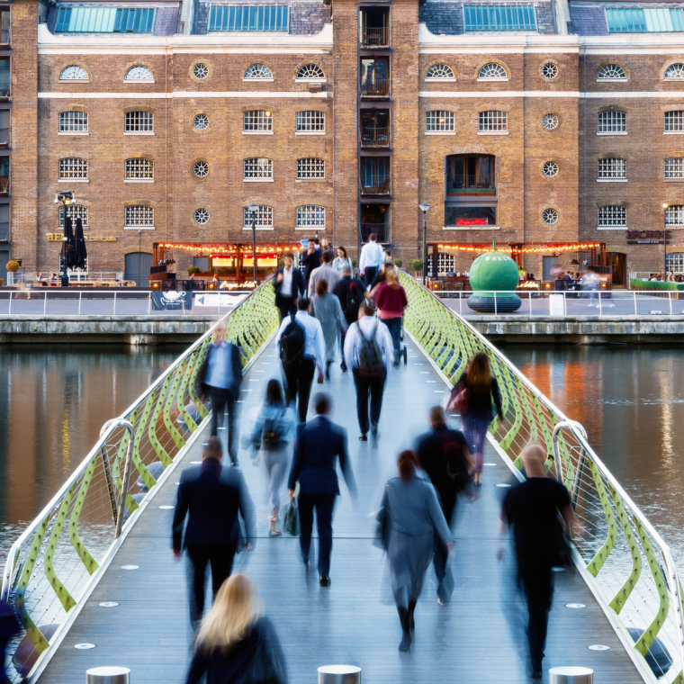North Dock Footbridge from Canary Wharf to West India Quay in London with unidentified crossing people 