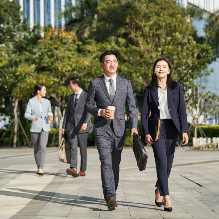 young asian businesspeople walking on street 