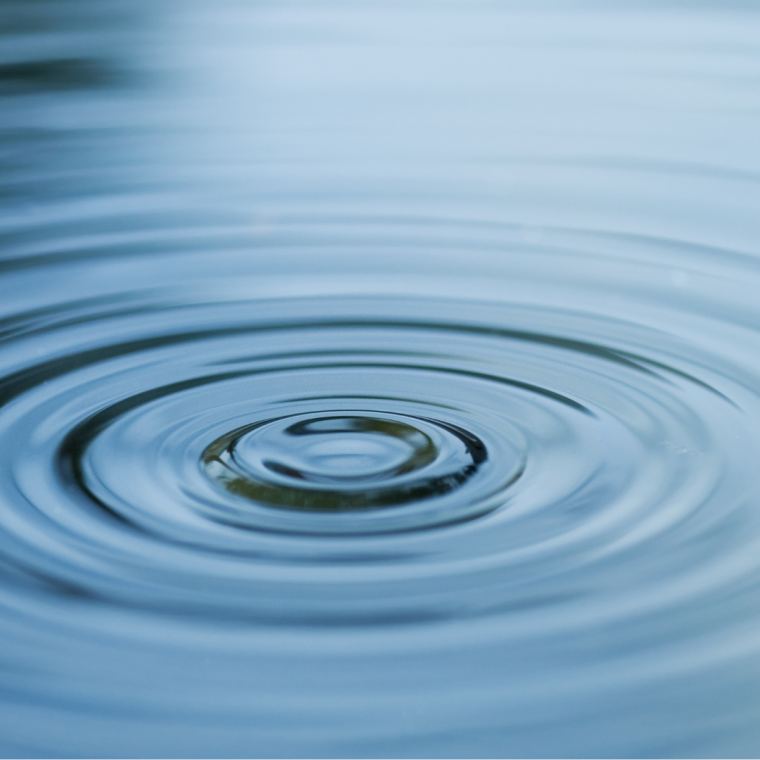 Droplet falling in blue water