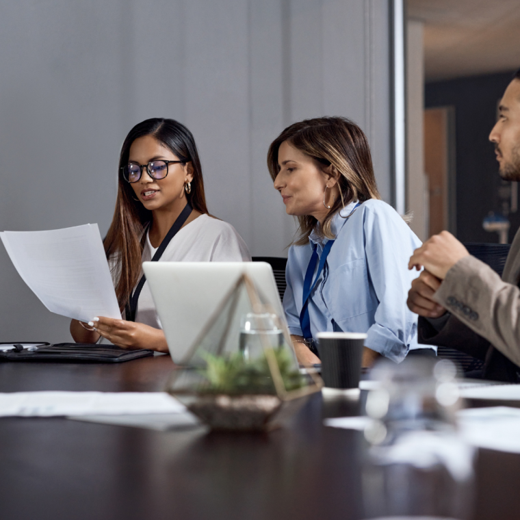 Business, team or meeting discussion with document for merger plan, integration review or valuation.