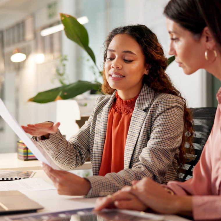 Business office, women team and talking with paperwork for policy review, laptop or corporate meeting