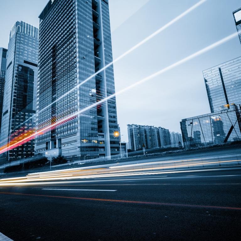 light trails against tall office buildings