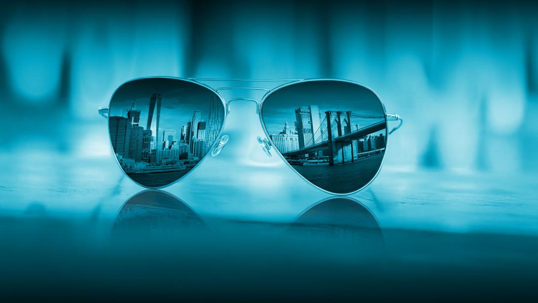 Aviator sunglasses reflecting a cityscape