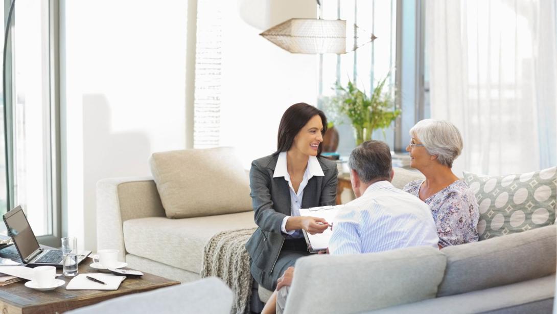 Financial advisor talking to couple on sofa
