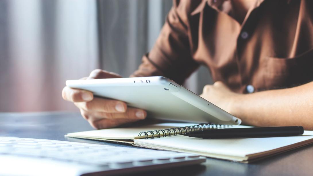 businessman working tablet in office with film colors tone, soft-focus and over light in the background