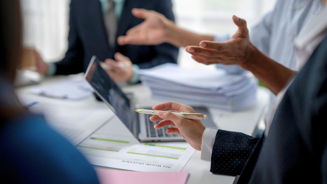 Corporate colleagues in a meeting discussing compliance