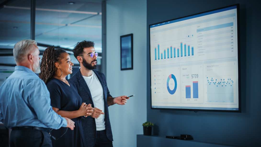 Company Operations Manager Holds Meeting Presentation. Diverse Team Uses TV Screen with Growth Analysis, Charts, Statistics and Data. People Work in Business Office.