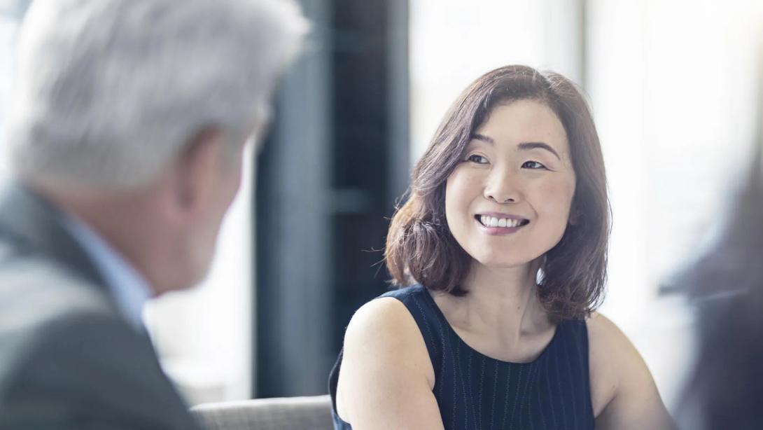 asian woman smiling in meeting