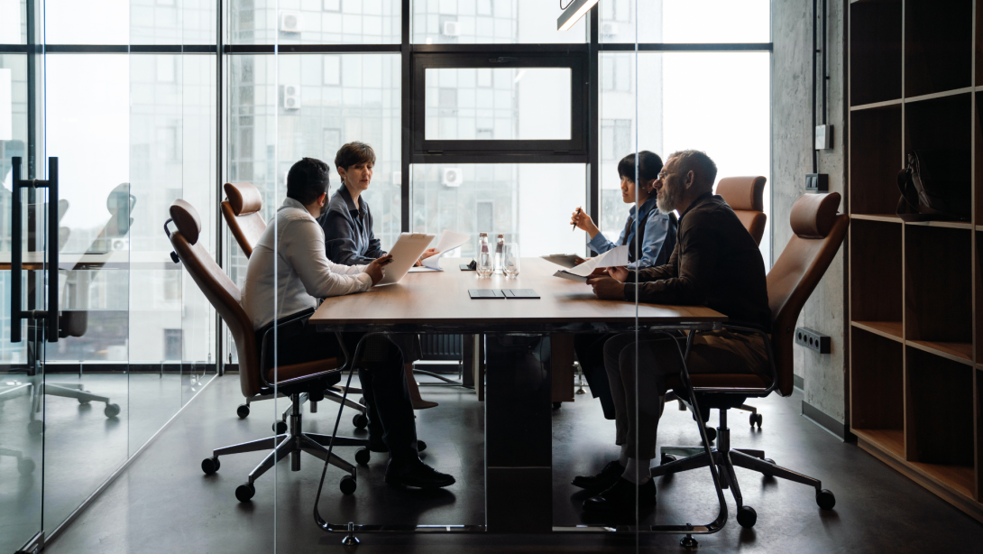 Professional confident multiethnic colleagues discussing work project in office