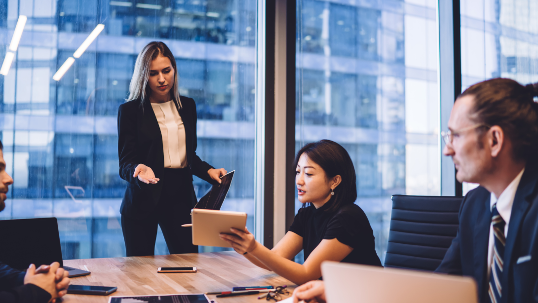 Serious businesswoman discussing project with diverse colleagues 