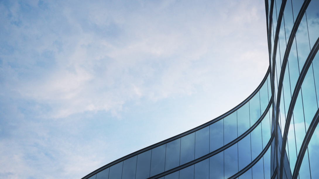 Perspective of high rise building and dark steel window system with clouds reflected on the glass.Business concept of future architecture,lookup to the angle of the building corner.