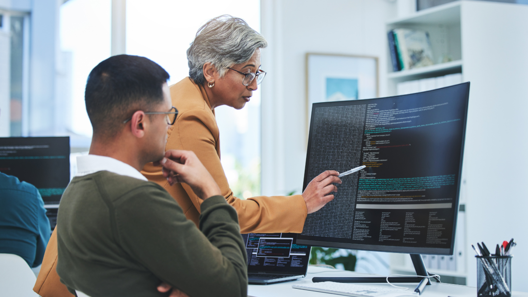 Coaching, mentor and programmer with business people and computer for coding, developer or information technology. Meeting, code review and feedback with employees in digital agency for cybersecurity
