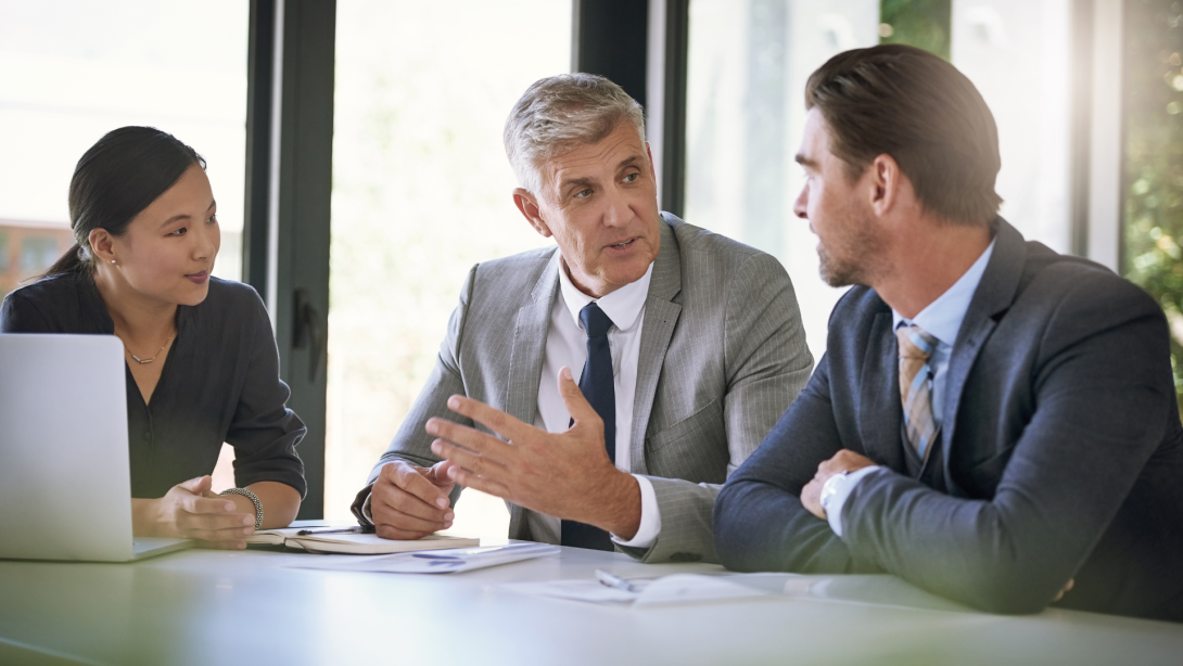 Meeting, collaboration and planning with a manager and team in the boardroom for a coaching seminar. Teamwork, strategy and workshop with a mature business man talking to his staff in the office