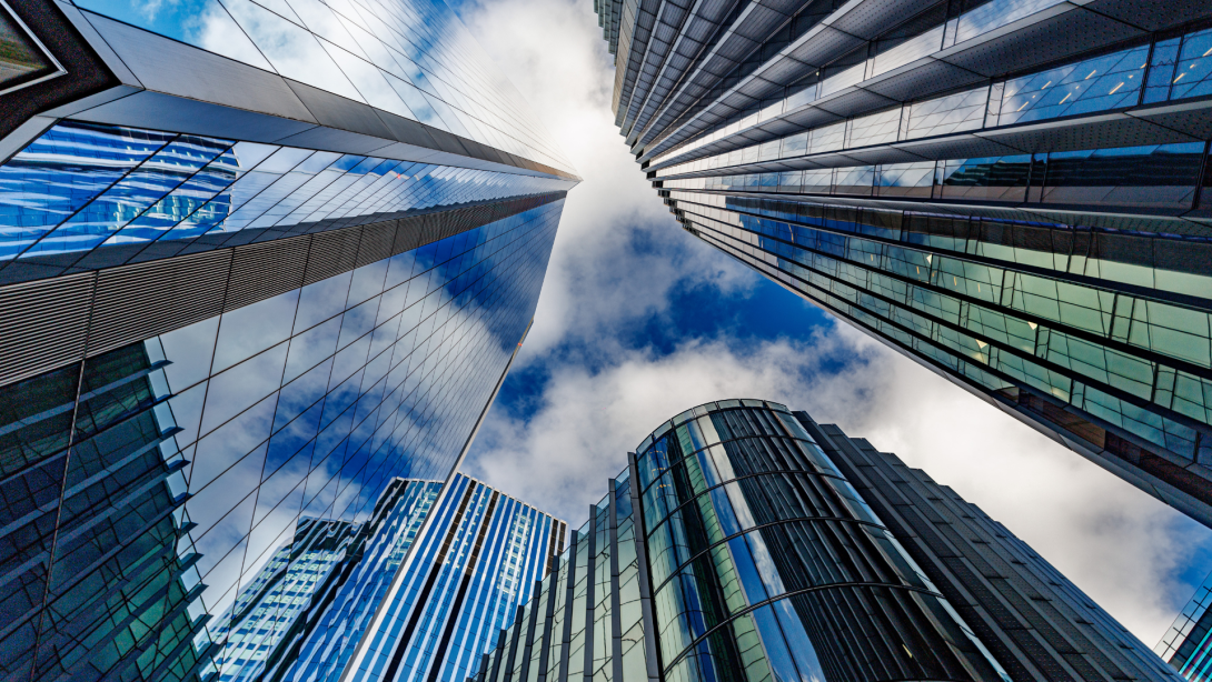 skyscraper buildings in business district, London City. Cloud on sunny day sky. Low angle view. Europe financial economy, merger and acquisition, or modern architecture concept, blue urban background
