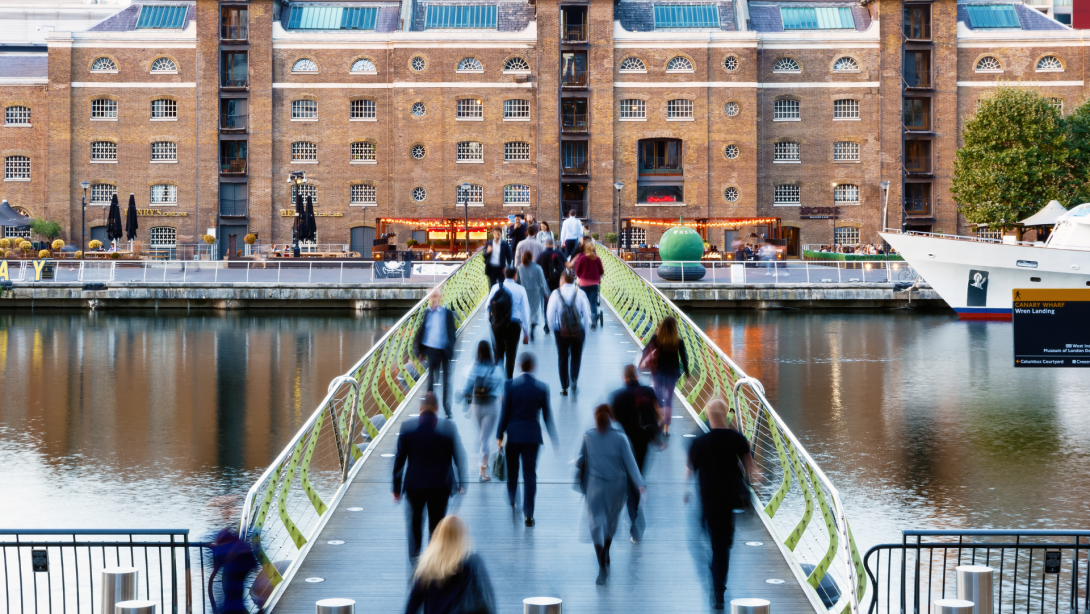 North Dock Footbridge from Canary Wharf to West India Quay in London with unidentified crossing people 