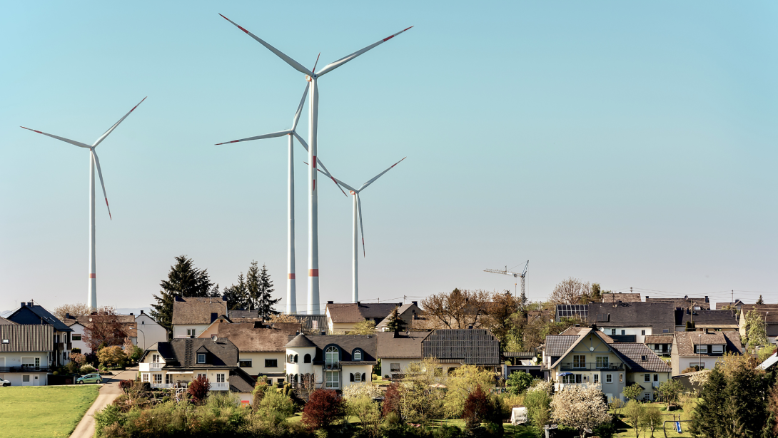 Wind turbines or a group of wind power converters in Germany against the backdrop of a sunny spring landscape on the road from Mörsdorf to the famous "Geierlay" suspension bridge.