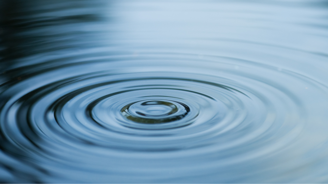 Droplet falling in blue water