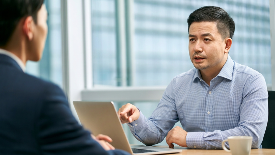 asian corporate executives discussing business in office